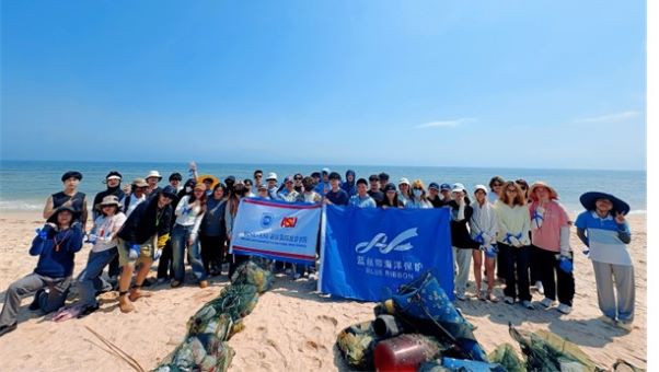 HAIC students on beach with ocean behind them